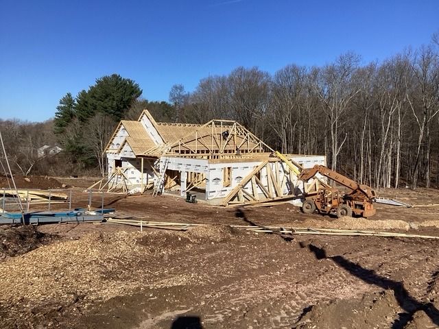 New house being framed on a cleared, graded lot